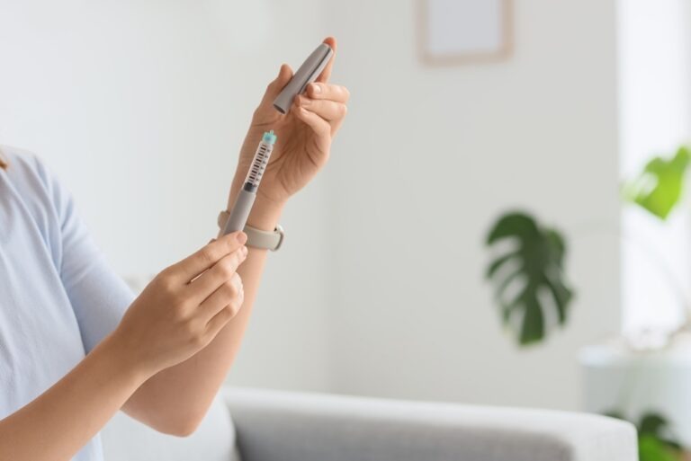 young,woman,with,syringe,of,ivf,hormones,at,home,,closeup